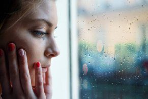 Woman staring outside window